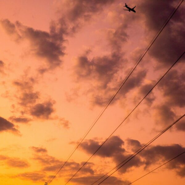 plane flying over power line
